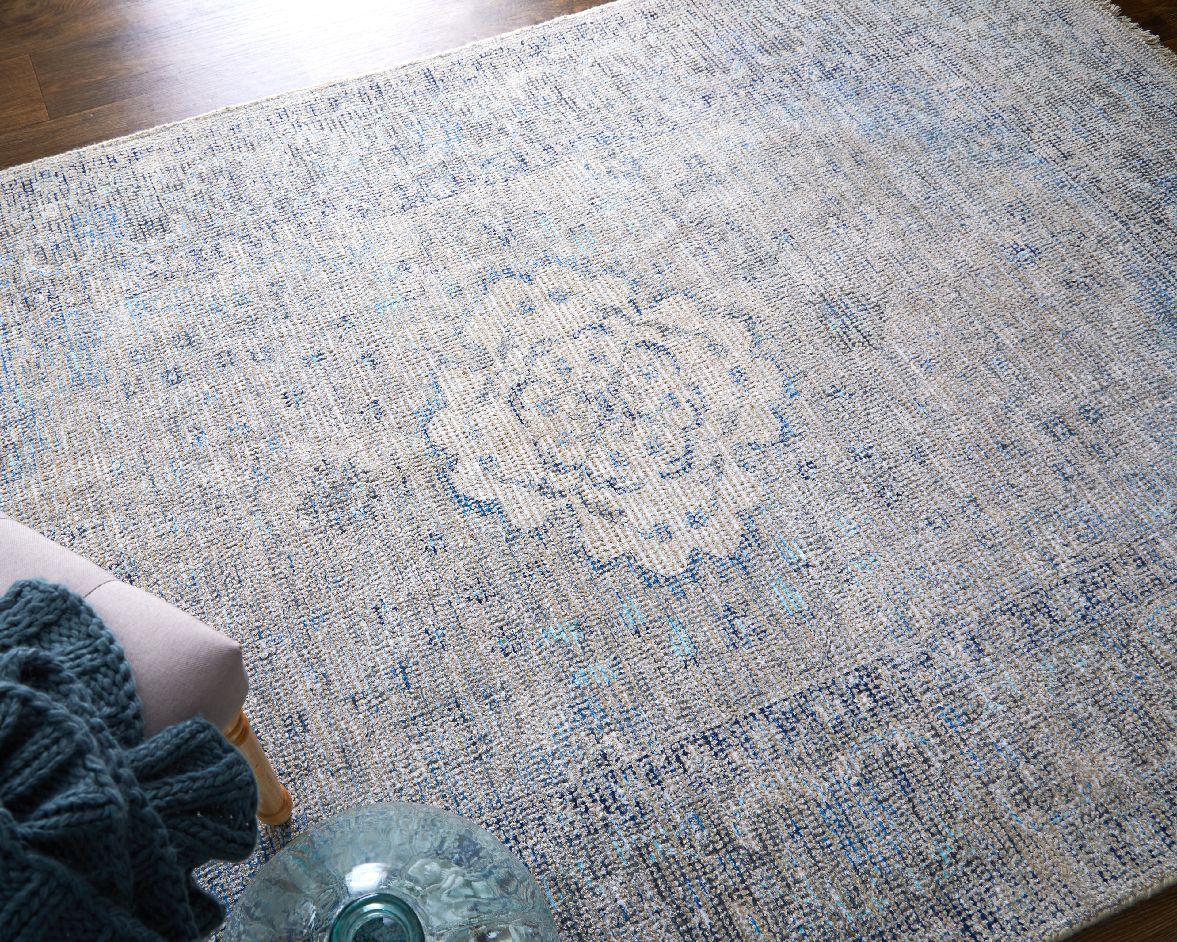 Caldwell Gray/Blue/Ivory rug styled in a room