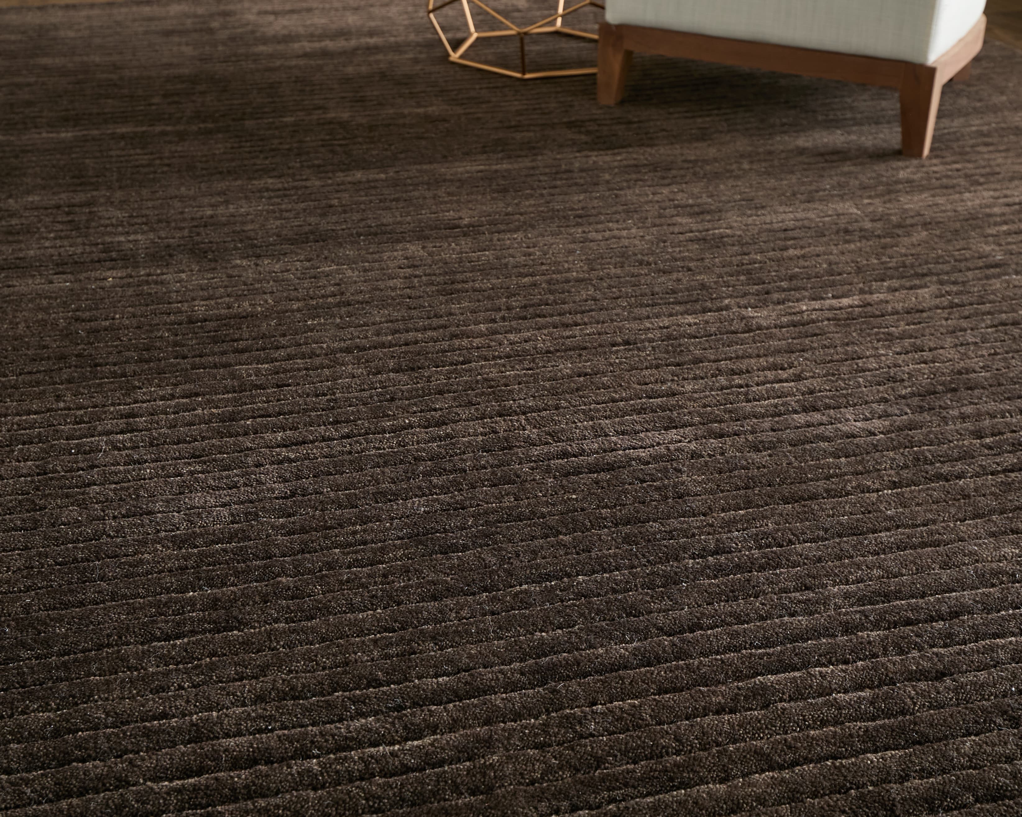 Contemporary Taupe rug styled in a room