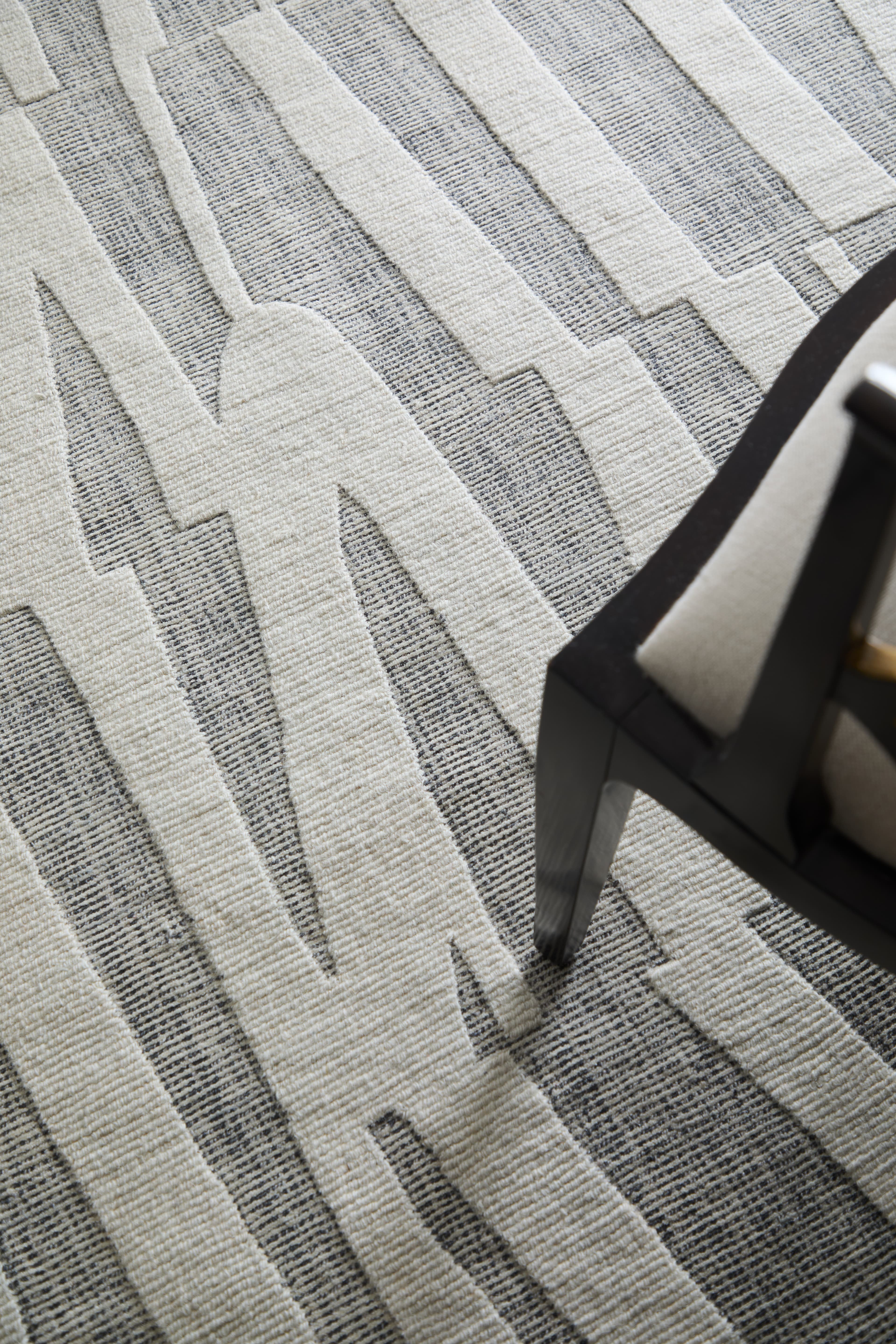 Contemporary Gray/Ivory rug styled in a room
