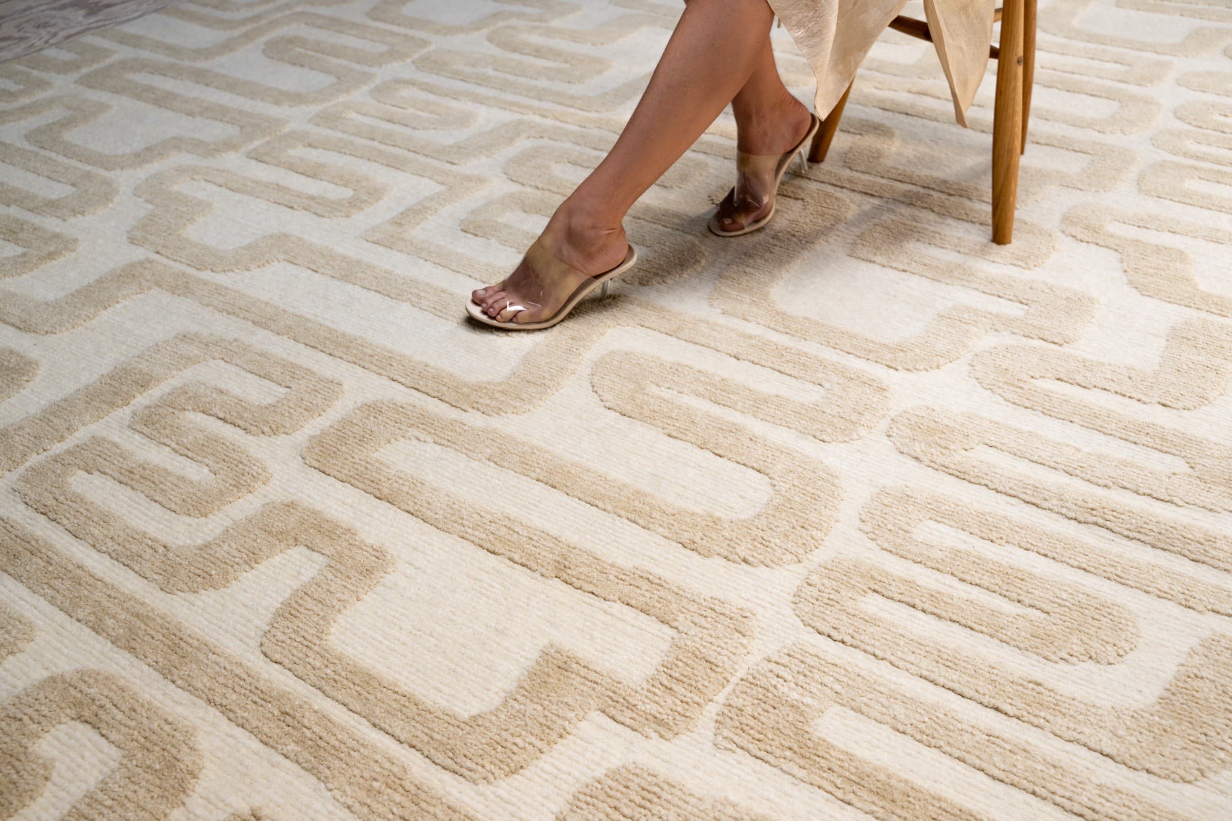 Geometric cream rug with a stool and props