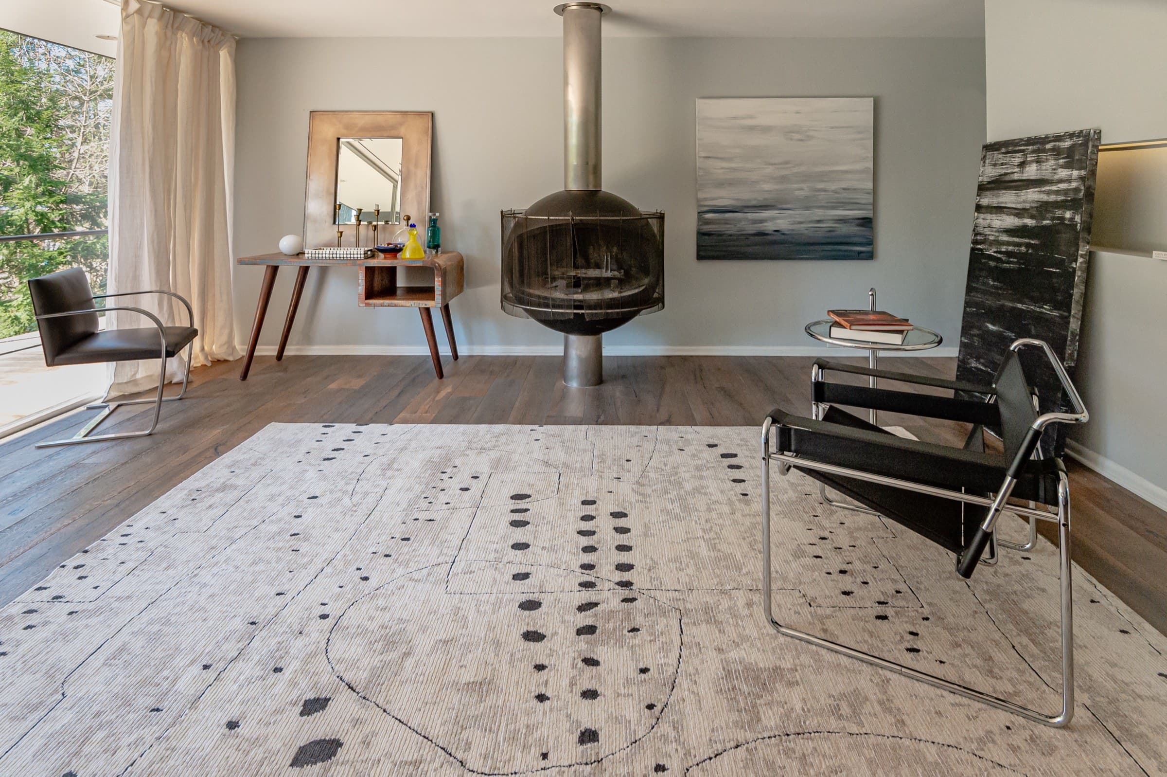 Abstract charcoal-on-cream rug in a modern loft living room